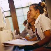 Two students working together on a computer assignment