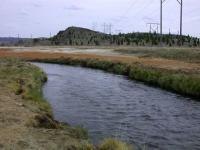 Silver Bow Creek with colored mineral deposits in the floodplain