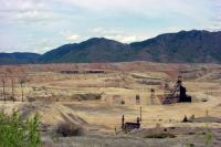 Depressing view of miles of waste rock and tailings dam above Butte
