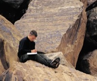 a student writing in a field notebook
