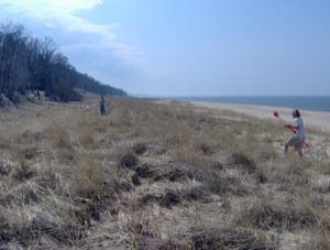 Jon Schmitkons measures erosion pins while Brent Geurink moves to another survey position on the foredune.