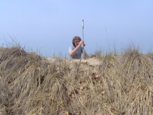 Jon Schmitkons measures an erosion pin at the study area