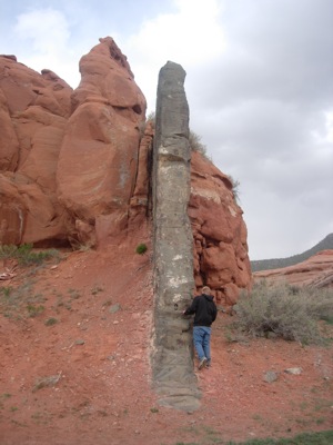 A student examining a mafic dike near Navajo, New Mexico.