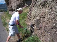 Student sampling rocks.