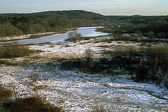 The Sudbury River flowing through a broad valley in winter.