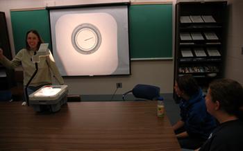 Beverly Saylor successfuly floats a needle to demonstrate surface tension