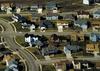 New suburban housing development illustrates mix of pavement and grass land cover.