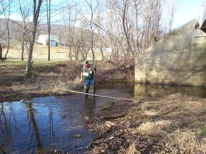 A man gauges a stream.