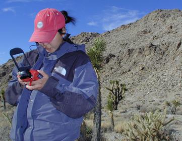 A student uses a GPS connected to a PDA to determine their location