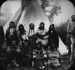 Crow tribe members in front of a teepee.