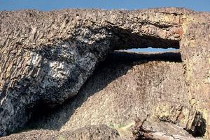 A massive basalt rock forms the Catherine Creek Arch along the Columbia River in Washington.