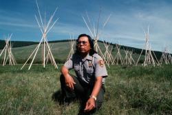 Otis Halfmoon, a U.S. Park Ranger, kneeling at BigHole Ntn