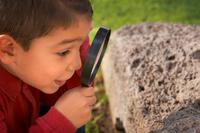 Child with magnifying glass