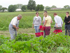 Farmer with Students in Field