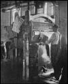 Photo of worker operating shoe manufacturing equipment