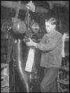 Photo of worker operating shoe manufacturing equipment