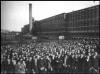 Crowd of workers photographed outside a shoe factory